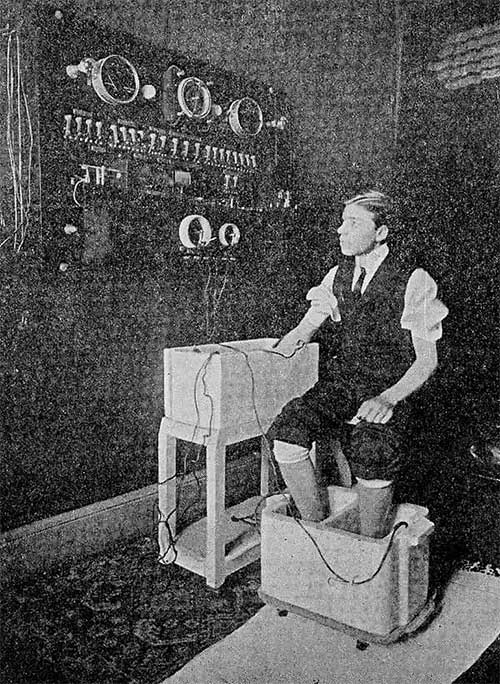 A man using hydroelectric bath therapy to treat his arms and feet.