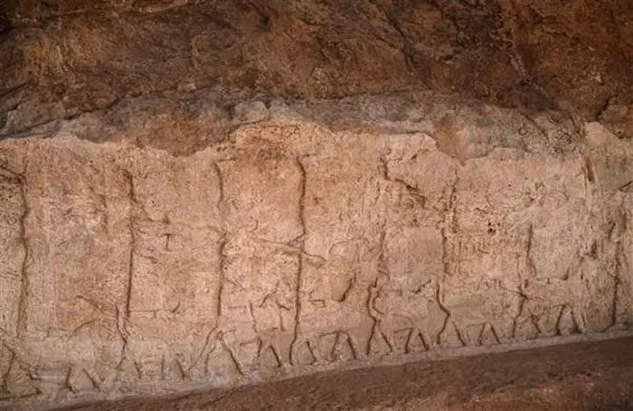 Stone relief integrated into the wall of an irrigation canal in Faida