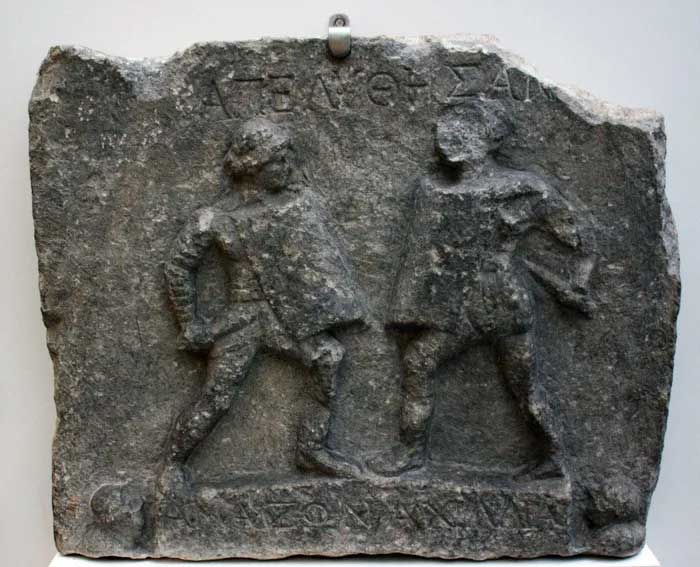Relief of two female gladiators fighting with swords and shields.