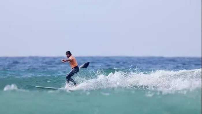 A great white shark leaps out of the water just a few meters away from surfer Tyler Warren.