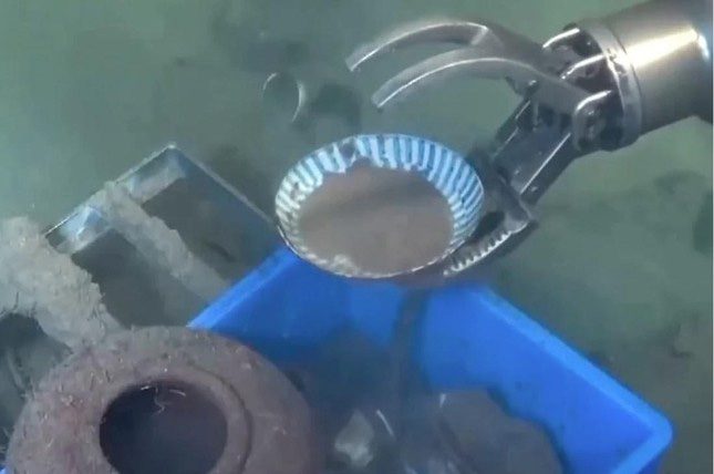 A robotic arm retrieves a porcelain artifact during an archaeological expedition in the South China Sea