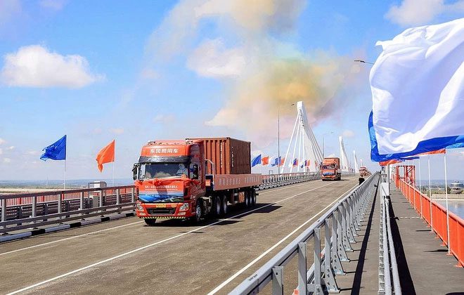 The first vehicles crossing the road bridge connecting Russia and China on June 10.