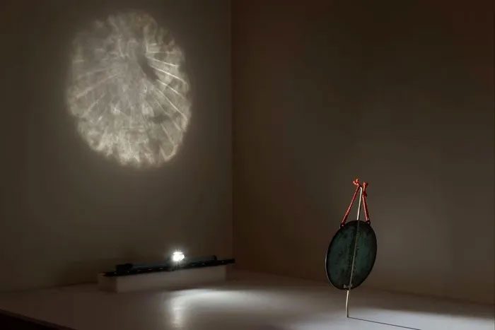 A magic mirror reflecting the image of a Buddha.