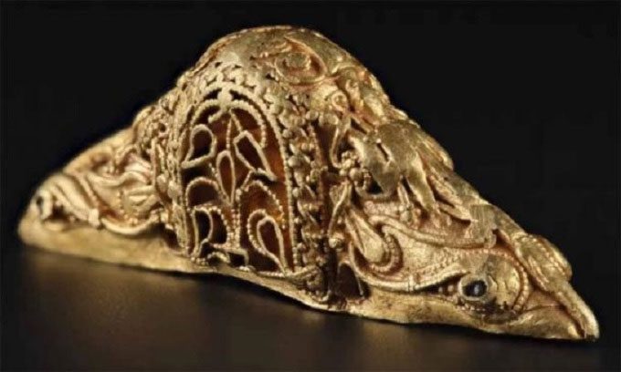Intricately carved gold sword hilt.