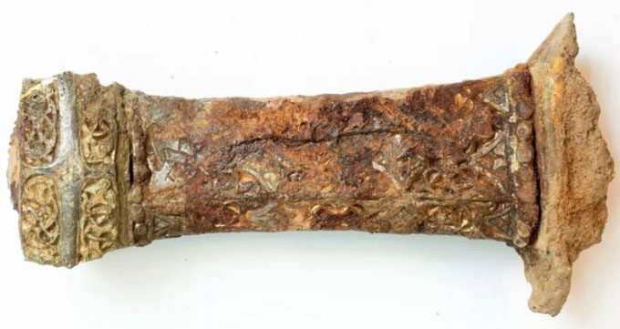The hilt of the Viking sword is intricately decorated.