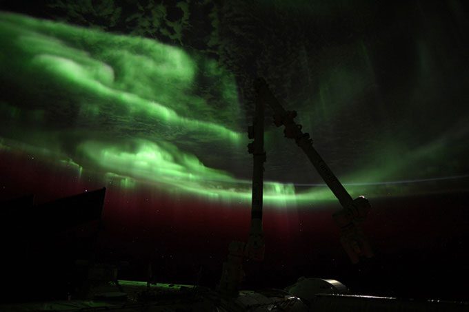 Green auroras caused by charged particles colliding with oxygen in the atmosphere