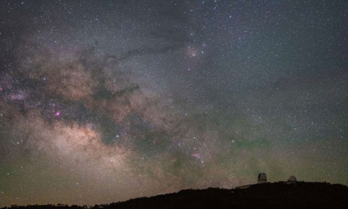 The Milky Way shines brightly against the dark sky above McDonald Observatory.