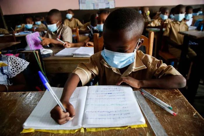 Students wearing masks attending school in Abidjan, Ivory Coast.