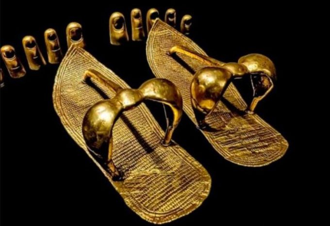 A pair of sandals with gold straps and toe caps in the tomb of King Tut.