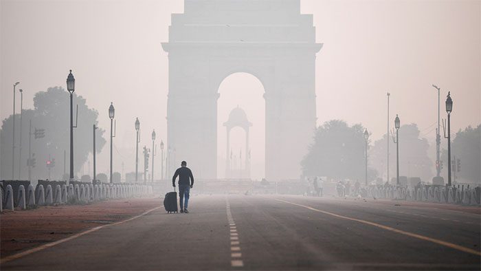 A man walking in polluted air in New Delhi, India.