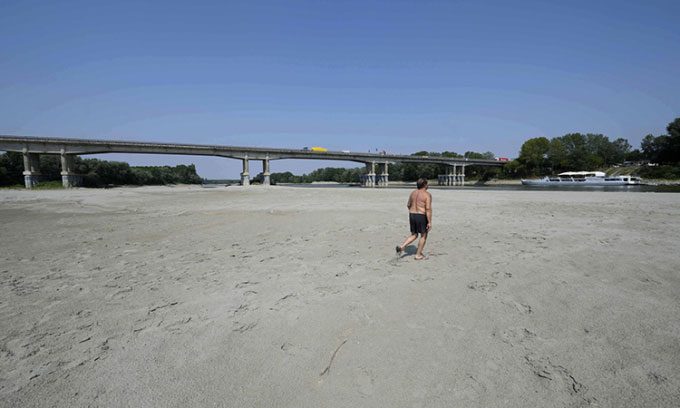 A man walking along the dry bed of the Po River in Boretto, Italy on June 15.