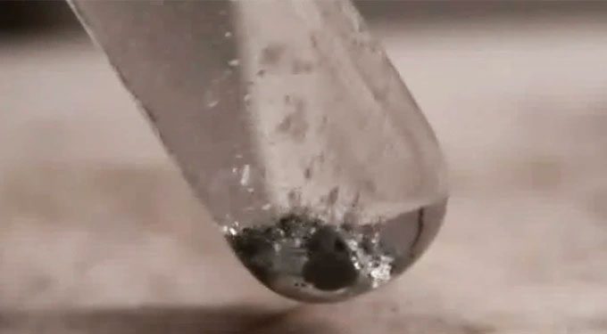 Hydrogen bubbles produced from the reaction between water and the aluminum-gallium mixture.
