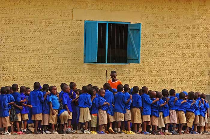 Children in Sierra Leone today in uniforms waiting to enter class.