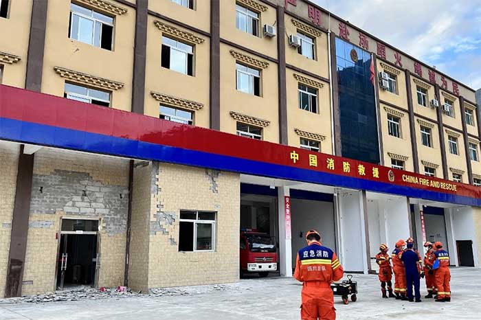 In the image, a headquarters of the Chinese fire brigade is damaged.