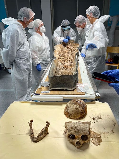 Researchers extracting remains from the coffin.