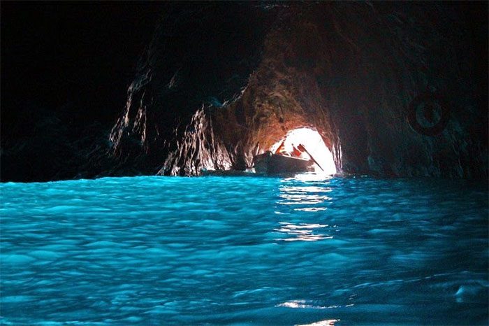 The large submerged hole beneath the cave entrance is the main source of light in this cave