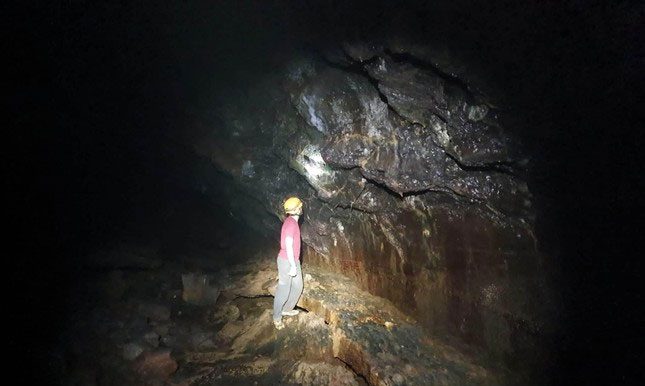 Mr. René Haemers - a Dutch cave expert exploring the new small passage of Cave C7