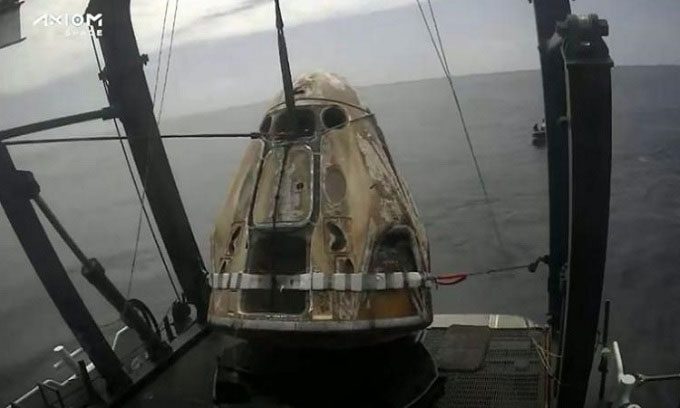 Crew Dragon capsule being pulled onto the boat