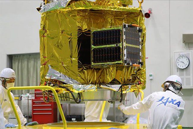 Japanese engineers installing the MicroDragon satellite
