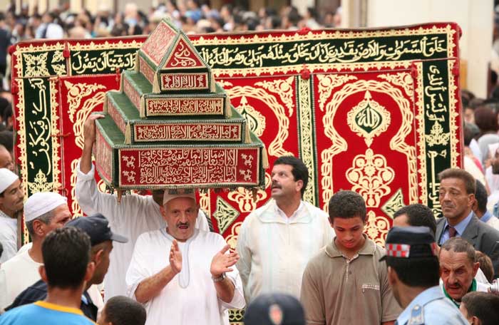 People parade to celebrate the Moussem of Moulay Idriss II festival.