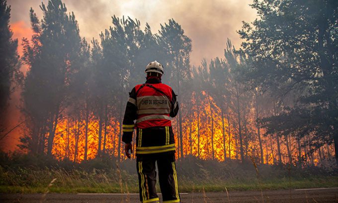 Firefighters tackling a blaze near Landiras, Gironde, southwestern France