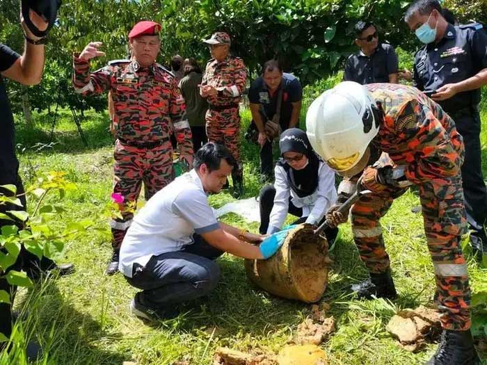 Firefighters in Sepupok, Malaysia inspecting debris