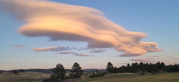 This is a lenticular cloud appearing on a hill in San Diego County, California.