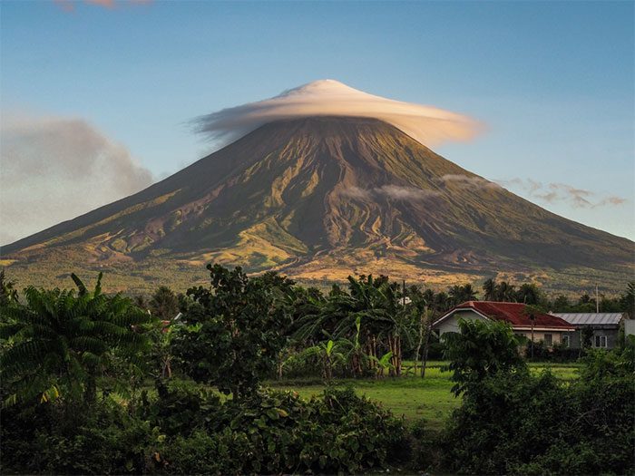 A giant lenticular cloud resembling a canopy over Mayon Volcano in the Philippines.