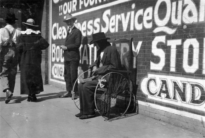 A blind beggar in a wheelchair in Lawton, Oklahoma, in 1917.