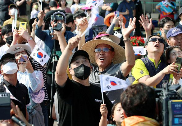 Korean citizens joyfully watching the Nuri space rocket launch