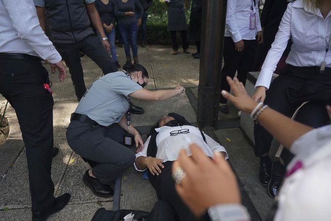 A woman in Mexico City receives assistance as people gather outside due to the earthquake