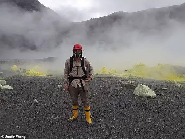 A scientist wearing a gas mask conducting field research at the "Death Lake" volcano