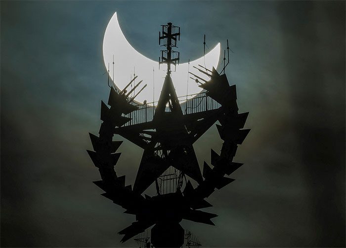 The Sun partially obscured behind the star symbol