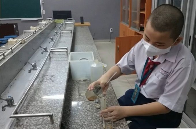 Hong Phuc preparing the material in the school laboratory.