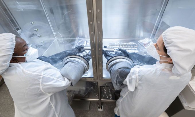 Scientists are very cautious during the opening of the lunar sample tube.
