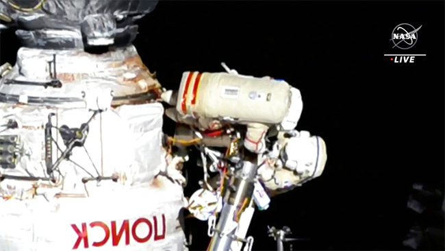 Astronaut Oleg Artemyev (top) and astronaut Denis Matveev working outside the ISS