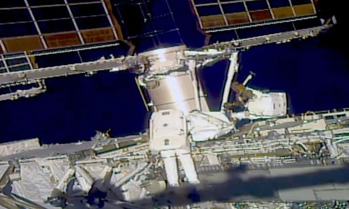 Astronauts Kayla Barron and Raja Chari conducting a spacewalk.
