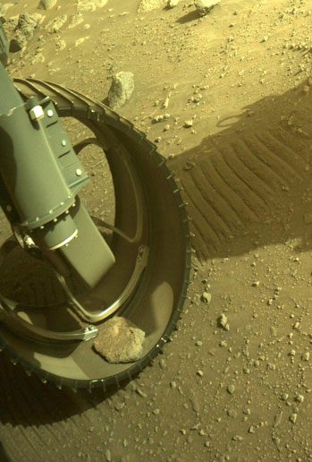 The image taken on March 10 shows the rock still lodged in Perseverance's wheel.
