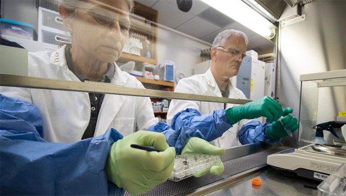 Scientists Anna-Lisa Paul (left) and Rob Ferl study lunar soil
