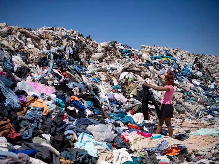 A woman "shopping" for old clothes from the "huge dump" in Atacama.