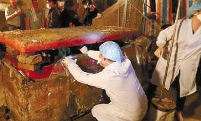 Archaeologists examining the strange coffin