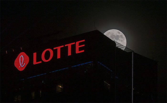 The supermoon peeking behind the top of the 63-story Hanoi Lotte Tower