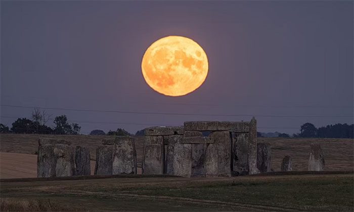The supermoon illuminates above the Stonehenge monument in Wiltshire, England.