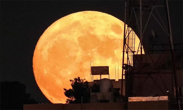 The moon rises behind a building in Amman, the capital of Jordan in the Middle East.