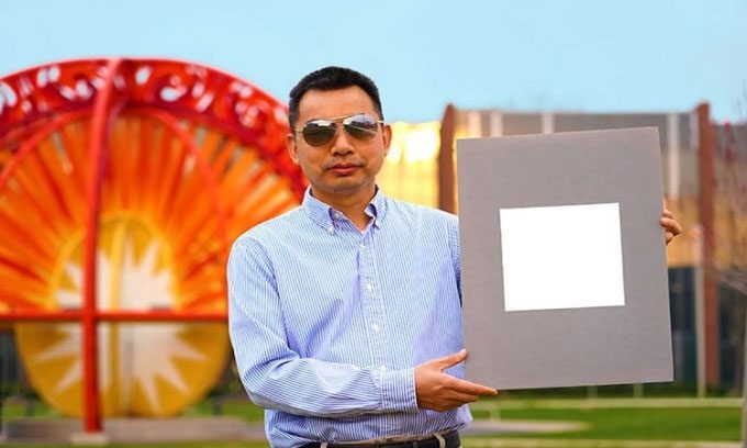 Researcher Xiulin Ruan and a sample of white paint.