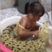 stunning girl naturally sitting in a bowl brushing teeth for crocodile 119283
