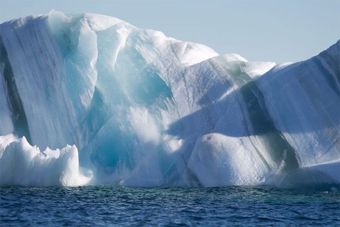 An iceberg with stripes from sediment it has collected.
