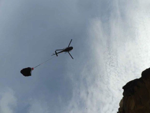 The rock being lifted by helicopter.