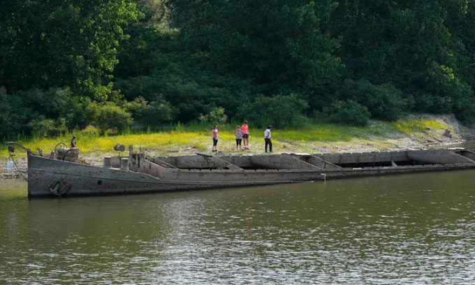 World War II shipwreck revealed on the surface of the Po River in Italy.