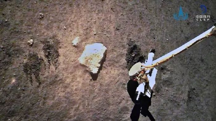 Chang'e-5 spacecraft collecting samples on the Moon.